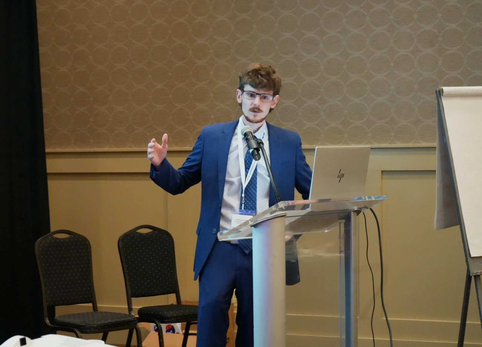 Matthew Miglio speaking at a podium